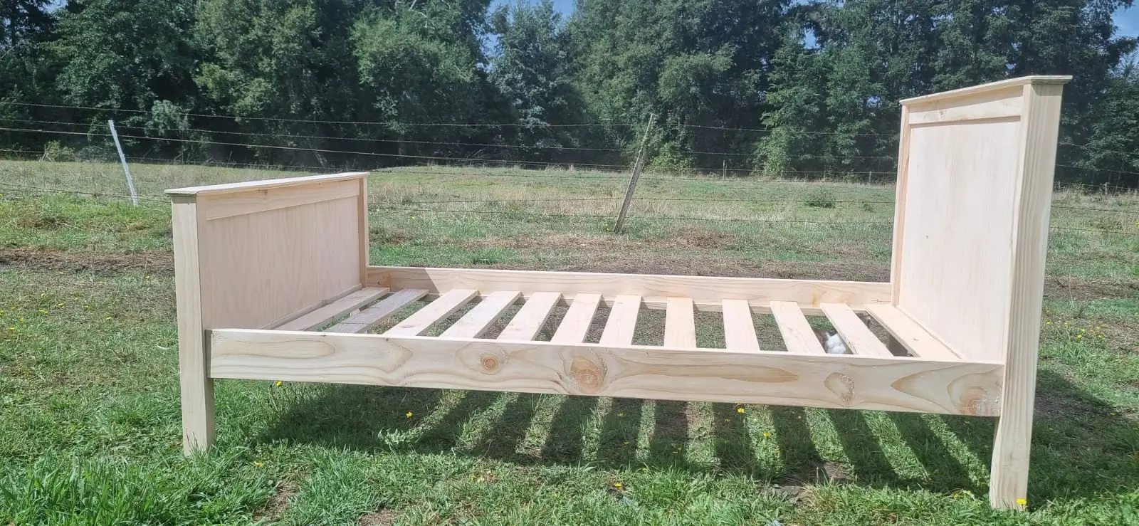 Cama doble en madera maciza con cabecera simple y acabado natural